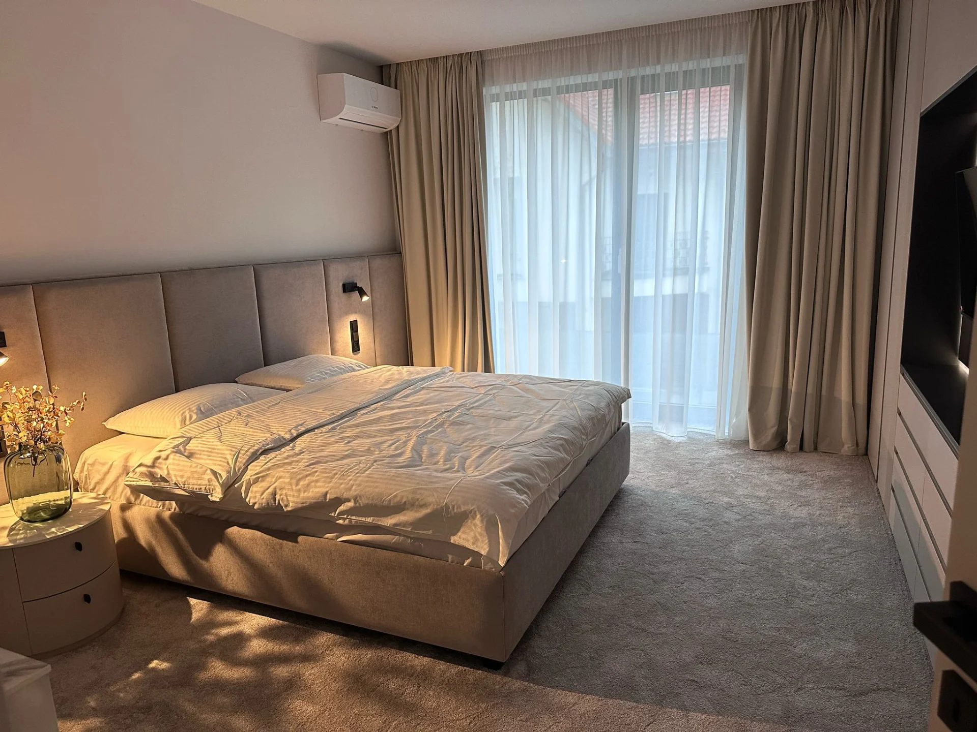 Custom bedroom furniture and upholstered headboard in a Spanish holiday residence